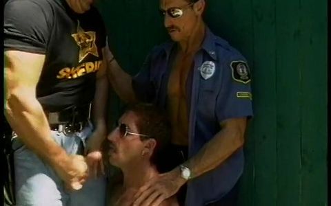 Two horny jacked gay cops and a hot perp get some sucking outside