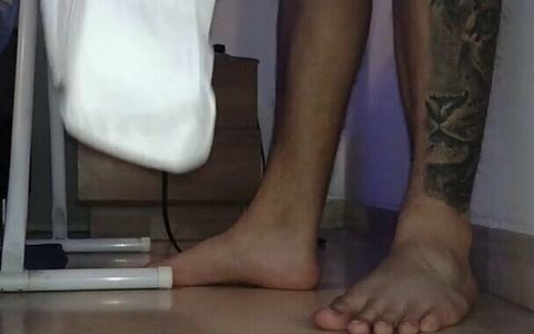 Man Shows His Feet While Ironing the Uniform