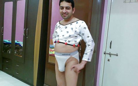 Hot crossdresser femboy Sweet Lollipop in a white crop top and thong.