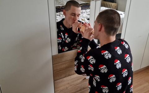 Naughty young horny daddy sucking big dildo in front of mirror dressed in Christmas sweater ...