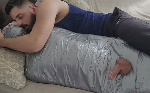 Bearded dom using mummified boy as a toy